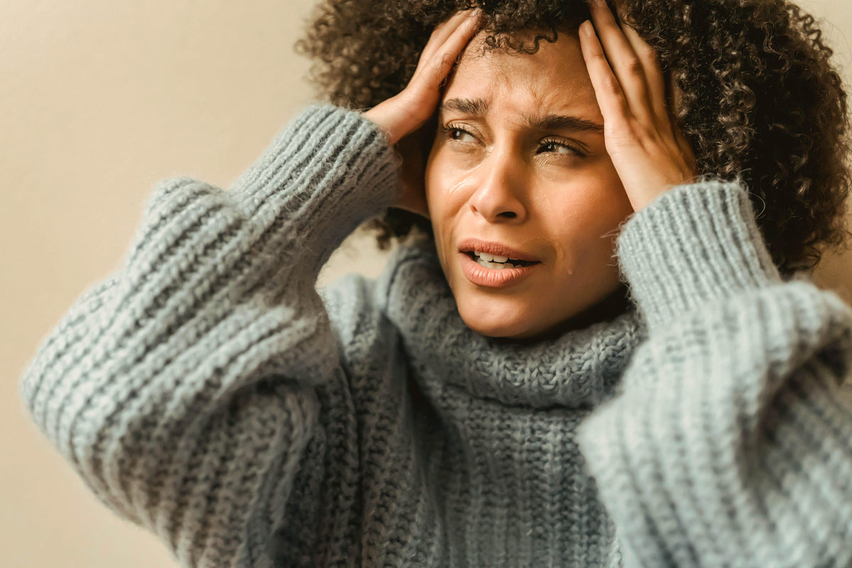 woman with a headache seeking relief with CBG
