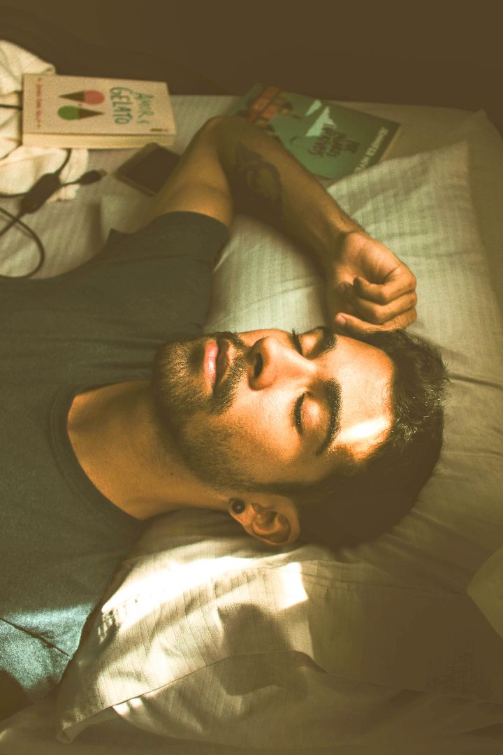 Man lying in bed , mind still racing 