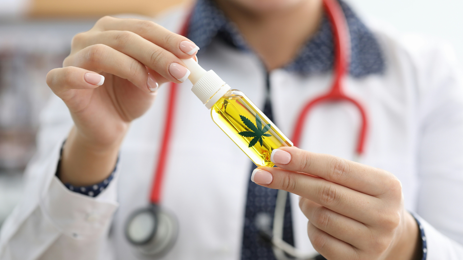 Female Doctor Holding A Bottle Of Cannabis Oil For Wellness Benefits